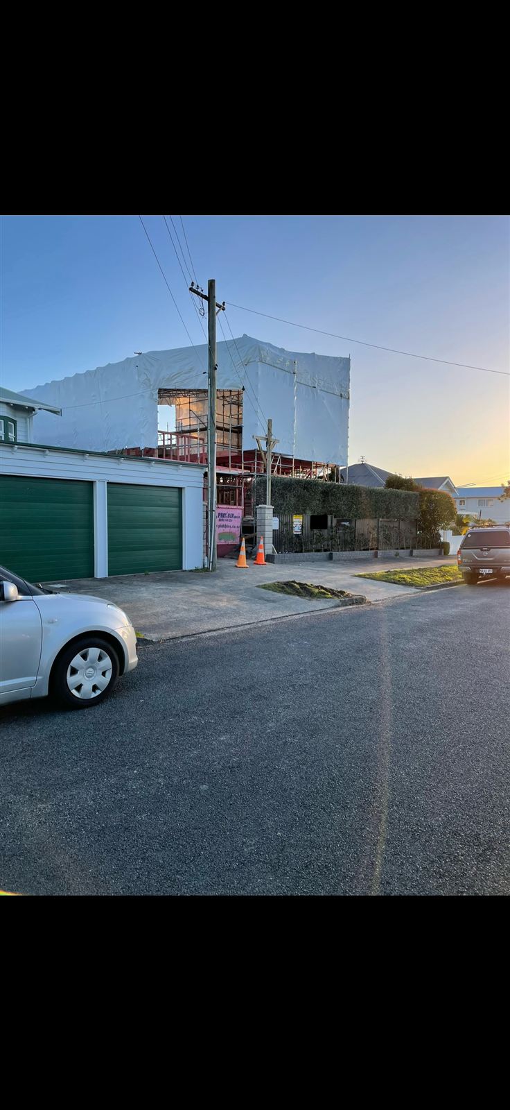 Second-storey extension wrapped in weathertight membrane during construction, street view