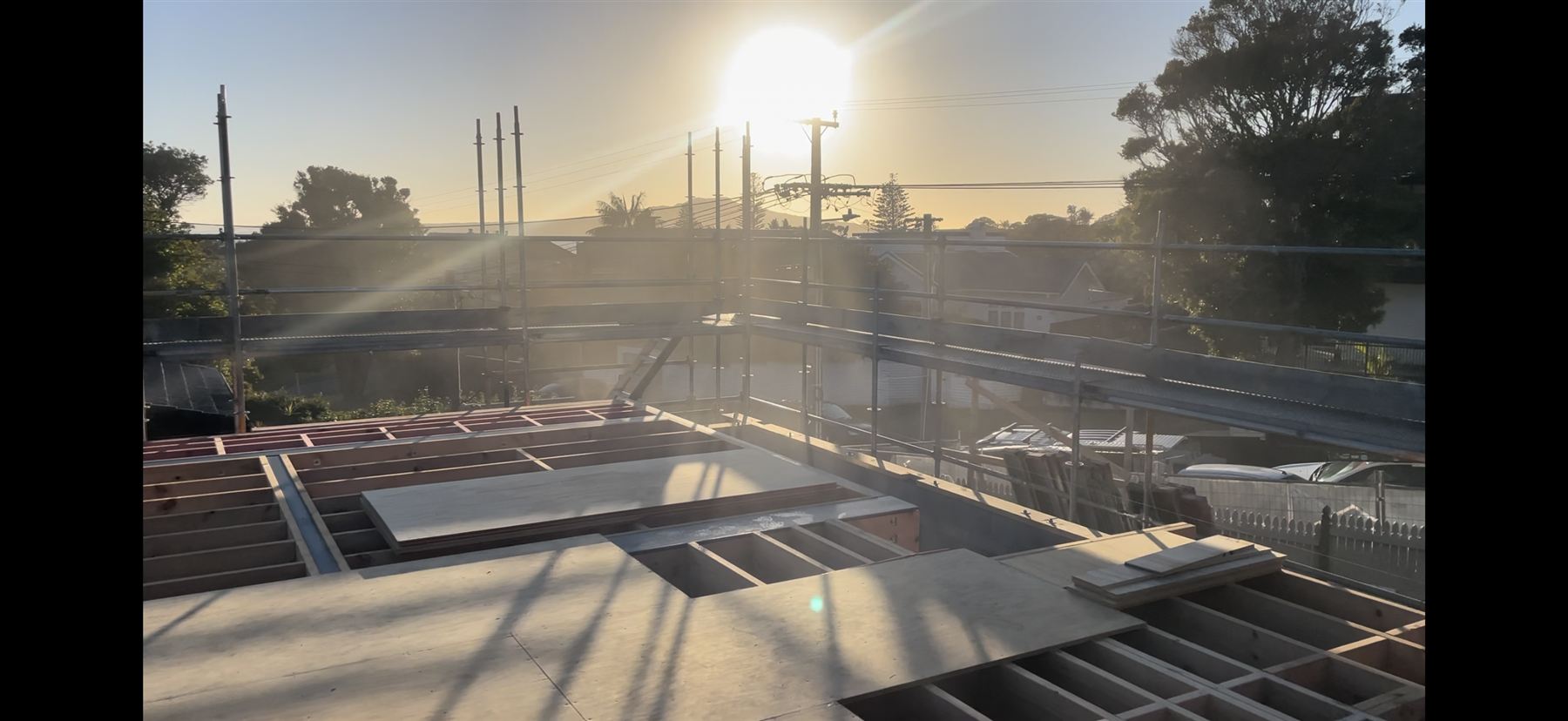 House framing at sunset on an Auckland construction site
